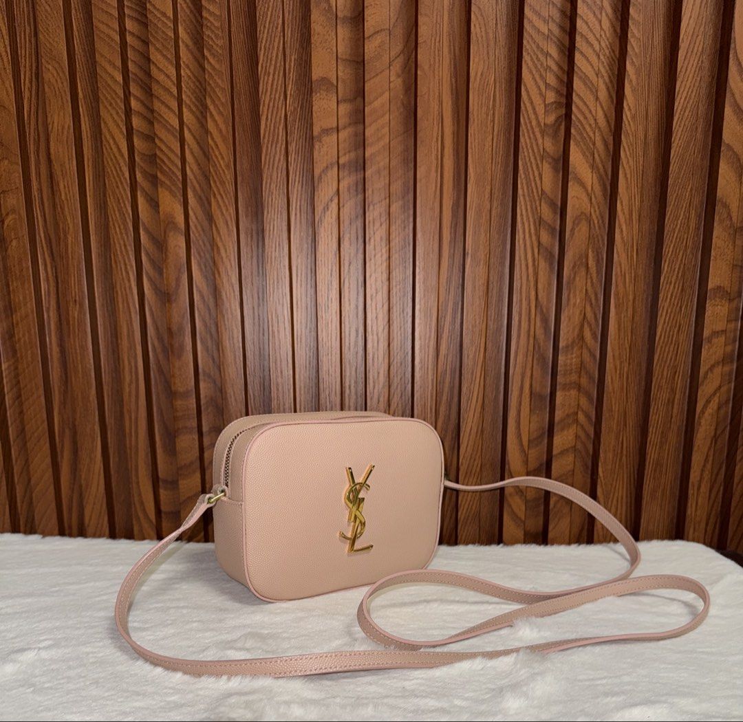 Authentic Saint Laurent YSL Camera Bag Leather (Category: Everything Else Others) located in Subic. Submitted by luxshoppe88 (Listing ID 1469707228, Image 2). Description: - Brand: Saint Laurent - Material: Premium textured leather - Hardware: Gold-tone YSL logo and matching strap rings - Closure: Secure zip top - Design: Structured rectangular shape with rounded corners - Condition: Pristine exterior with clean corners - Inclusion: Adjustable ma