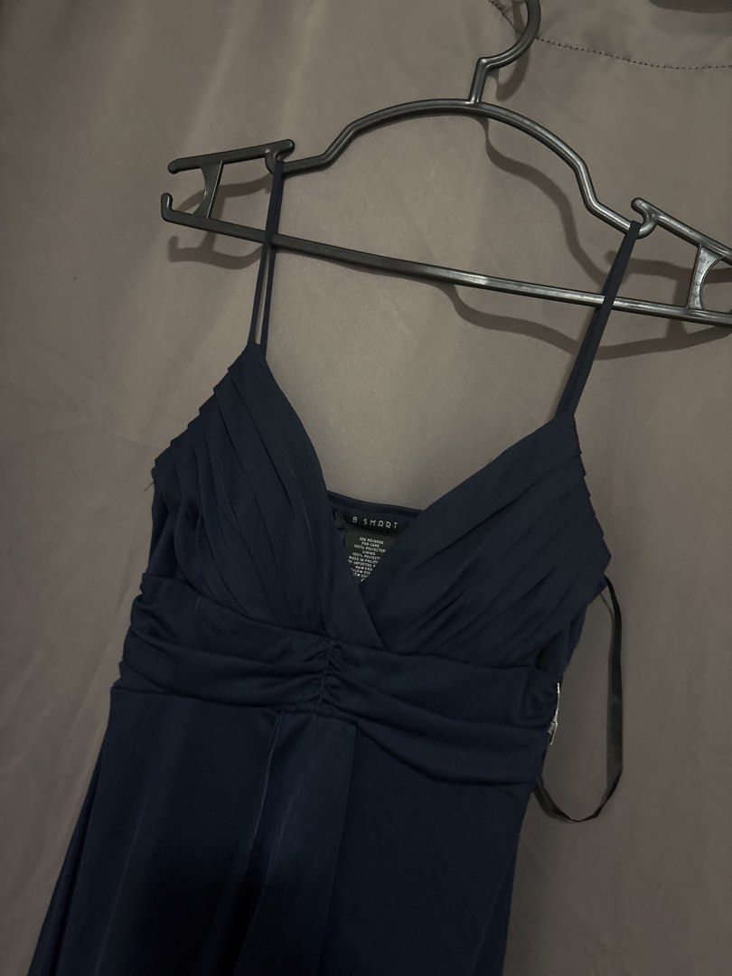 B. Smart Navy Blue Spaghetti Strap Maxi Dress (Category: Evening dresses & gowns) located in Cabuyao City. Submitted by airpz (Listing ID 1469669147, Image 2). Description: - Color: Smart navy blue - Style: Long dress with spaghetti straps, pleated bodice, and gathered waist - Details: Flowy skirt with a stylish draped front accent - Material: 100% polyester shell and lining (Made in Philippines).