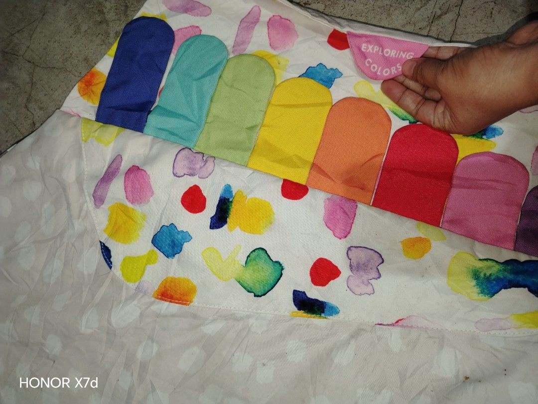 Baby Activity Mat Multi-sensory Play Gym (Category: Infant Playtime) located in Manila. Submitted by mimachelleukay (Listing ID 1469601612, Image 3). Description: Multi-sensory baby activity mat with different tactile sections like textures, colors, sounds, and hiding games. Multiple interactive tags and colorful sections help with sensory development. Shows some dirt spots and wear from usage, needs a wash. Plastic clear pocket has creases..