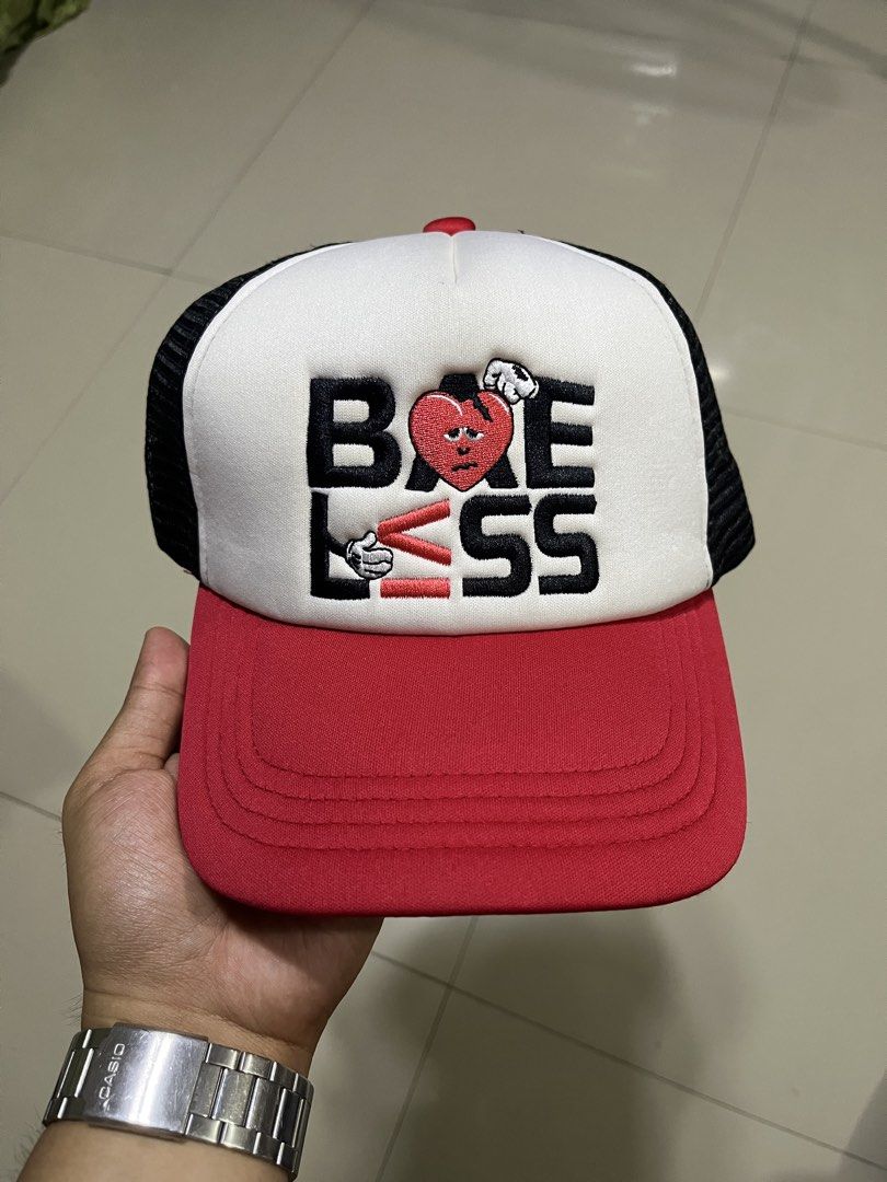 Bae Less Trucker Hat Red Black White Embroidered (Category: Caps & Hats) located in Quezon City. Submitted by flip_da_cash (Listing ID 1469648680, Image 1). Description: Trucker hat with 'BAELESS' embroidered graphic on the front featuring a sad heart character. Red brim and front panel, white foam crown, and black mesh back. Adjustable plastic snapback closure. Interior black sweatband and structured lining..