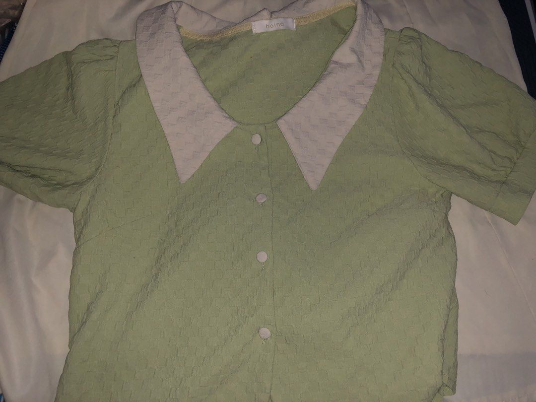 Baina Green Blouse with Contrast Collar (Category: Blouses) located in Manila. Submitted by seethestarrz (Listing ID 1469727023, Image 1). Description: - Brand: Baina - Color: Sage green with white contrast pointy collar - Material: Textured fabric throughout - Details: Front closure with four round buttons, puff sleeves with subtle shoulder gathering 📍qc, metro manila 🚚 jnt, sf shouldered by buyer dm for more details!'.