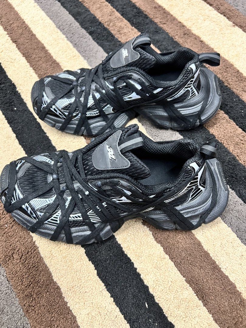 Balenciaga 3XL Black Sneakers (Category: Sneakers) located in Ilagan. Submitted by stargirldotph (Listing ID 1469620656, Image 1). Description: - Brand: Balenciaga - Model: 3XL Sneakers - Color: Black with grey accents - Design: Chunky silhouette wrapped in extra laces - Details: Branded tongue patch with '3XL' lettering - Branding: Embossed 'BALENCIAGA' text on the toe bumper - Convenience: Pull tabs at the heel and tongue - Material: Premium me