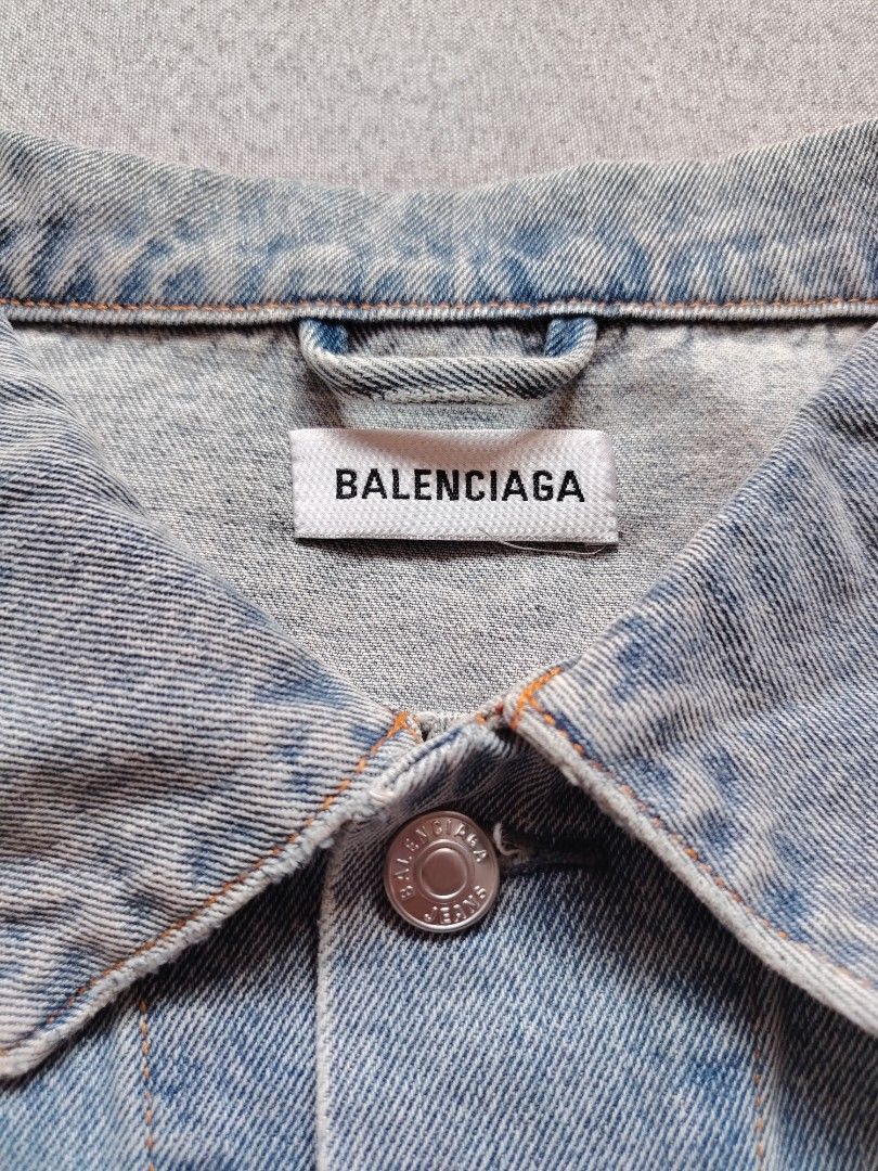 BALENCIAGA Washed Denim Jacket (Rhinestone Back Logo) (Category: Luxury Apparel) located in Taguig. Submitted by _theroom.ph (Listing ID 1469637088, Image 3). Description: - Brand: Balenciaga - Style: Oversized denim jacket with button closure and chest pockets - Wash: Light blue - Size: 36 (Made in Italy) - Details: Eye-catching sparkly rhinestone 'Balenciaga' logo on the back - Hardware: Heavy branded metal buttons - Condition: Excellent / Well