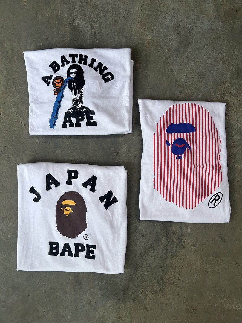 BAPE (Category: Tshirts & Polo Shirts ) located in Las Pinas. Submitted by 2fly.margiela (Listing ID 1469758411, Image 3). Description: - Set of 3 white BAPE graphic tees - Designs include Japan logo, striped ape head, and graphic print - Standard crew neck style with classic branding - Perfect for Japanese streetwear rotation.
