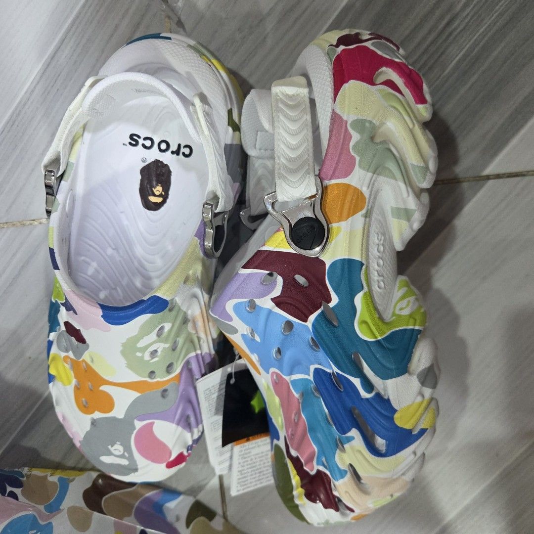 BAPE x Crocs Echo Clogs Multi Color (Category: Slippers & Slides) located in Manila. Submitted by sik2find (Listing ID 1469706610, Image 3). Description: -SIZE M5 - Brand new with tags in original packaging bag - Authentic BAPE x Crocs Echo Clogs collaboration - Multi-color camo pattern with glow-in-the-dark material - Includes extra Jibbitz charms pack (Ape Head, BAPE logo, and bee design) - Men Size M6/W8 (EU 38-39) - 100% authentic and ready t