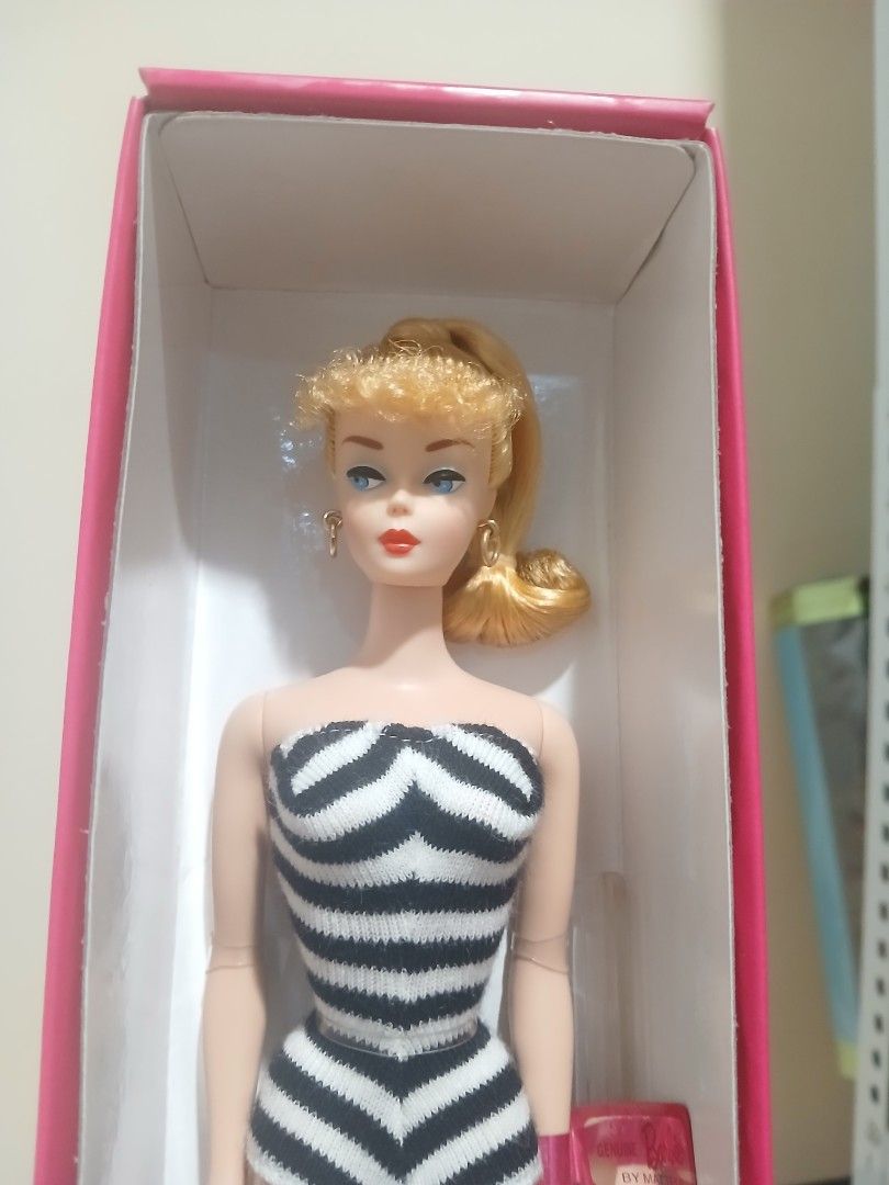 Barbie Black and White Bathing Suit Doll (Category: Kids Toys) located in Subic. Submitted by frncnjntmr22 (Listing ID 1469725060, Image 2). Description: - Brand new and 100% unopened in original packaging - 1959 replica Barbie in the iconic zebra stripe swimsuit - Complete with signature ponytail, gold hoop earrings, sunglasses, and open-toe heels - Includes a black display stand - Comes in a stunning pink collector box with silhouette graphics 