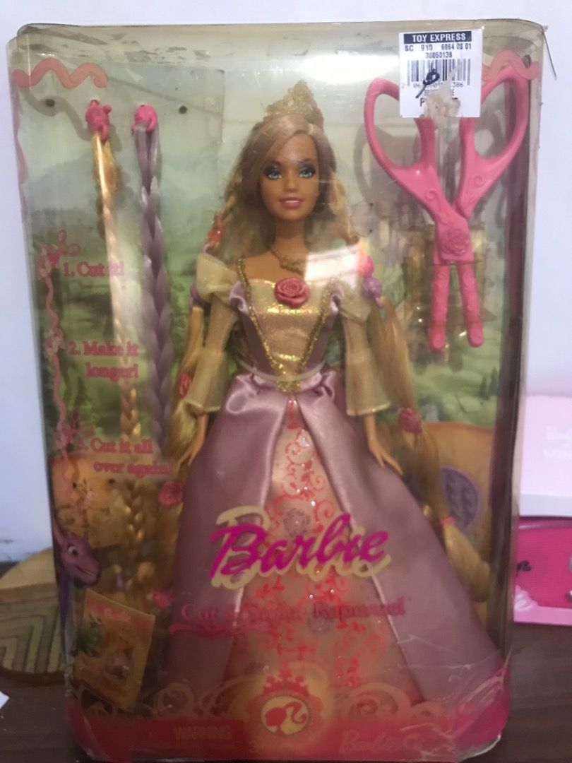 Barbie Cut 'n Style Rapunzel Doll (Category: Kids Toys) located in Arayat. Submitted by ipogladys (Listing ID 1469652384, Image 1). Description: - Includes Rapunzel in a gorgeous pink and gold gown - Comes with fun accessories: extra hair extensions and styling scissors - Rare collectible piece featuring an original toy store price tag - Note: Box shows minor shelf wear and creasing on the plastic window.