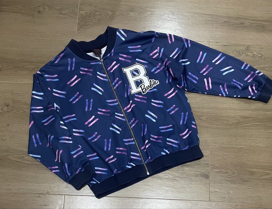 Barbie Forever Lightweight Jacket – Size Large (L) 💕 (Category: Coats, Jackets and Outerwear) located in Bulacan. Submitted by ladyjagged (Listing ID 1469717160, Image 1). Description: * Size: Large (L) * Color: Navy Blue with colorful accents * Lightweight and breathable fabric * Full front zipper closure * Ribbed collar, cuffs, and hem * Stylish Barbie logo on the chest * Comfortable and easy to pair with any outfit.
