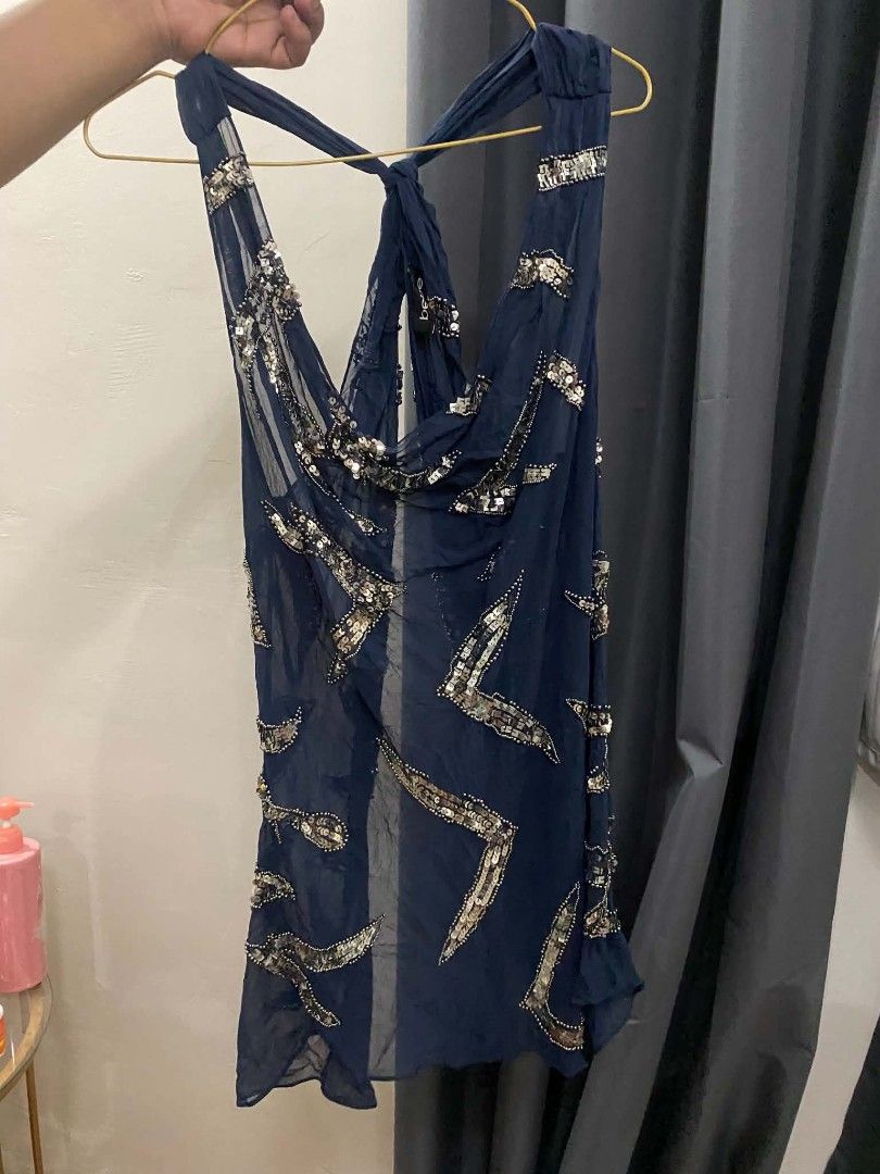 bebe Navy Blue Sequin Halter Neck (Category: Dresses) located in Malasiqui. Submitted by finnley26 (Listing ID 1469588515, Image 2). Description: - Color: Navy blue with intricate silver sequin and bead patterns - Style: Sleeveless halter neck, mini length, sheer fabric with draped cowl neckline - Details: Tied back closure, brand tag attached inside - Condition: Brand new with tag - Perfect for: Parties, clubbing, and special events.