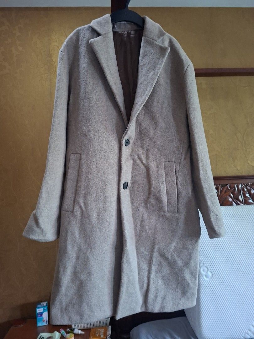Beige woolen trench coat winter outerwear (Category: Coats, Jackets and Outerwear) located in Quezon City. Submitted by apple.ana888 (Listing ID 1469628463, Image 1). Description: - Color: Elegant beige - Material: Warm wool-blend, fully lined interior - Style: Double-breasted front with two dark buttons and classic lapel collar - Length: Medium - Features: Two functional front pockets - Condition: Great for cold weather layering.