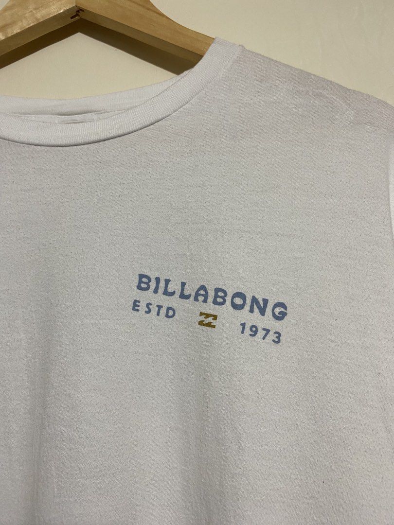 BILLABONG,T-shirt (Category: Tshirts & Polo Shirts ) located in Cavite. Submitted by jc_thrift95 (Listing ID 1469614671, Image 3). Description: - a white Billabong short-sleeve crewneck T-shirt featuring a small chest graphic reading “BILLABONG ESTD 1973” - Made in Mexico - L- 28 inch - W- 22 inch - Color rate 8/10 - See picture details for dimes..