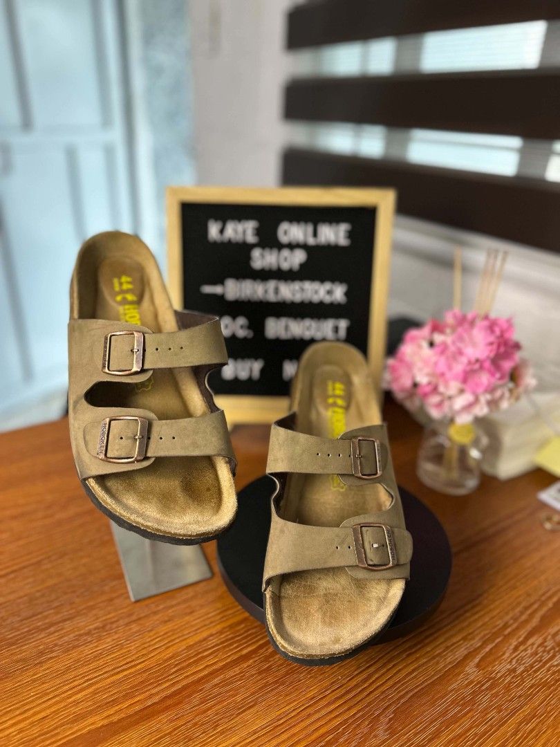 Hoboken two-strap slip-on sandals (Category: Slippers & Slides) located in Baguio. Submitted by kayeonlineshop (Listing ID 1469615940, Image 2). Description: Birkenstock Arizona sandals in a brown or taupe shade with a two-strap buckle design. color:brown size:44/240.