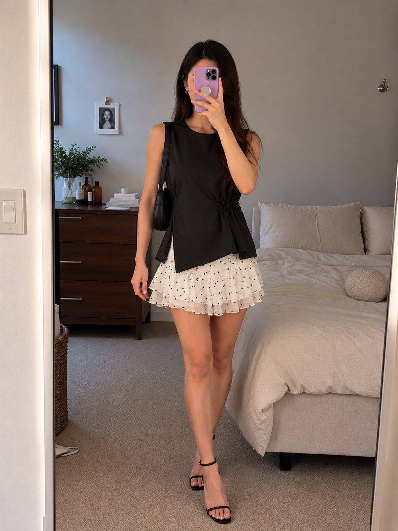 BKK Black Sleeveless Ruched Blouse Top (Category: Sleeveless) located in Taguig. Submitted by sherylannc (Listing ID 1469626494, Image 1). Description: - Brand: BKK (Brand New With Tag) - Color: Sleek black with a smooth, slight-sheen fabric - Fit: Relaxed upper body with gathered elastic sides for a defined waist - Design: Round neckline, flared hem, and trendy asymmetric side draping - Versatility: Perfect for both casual days and dressy night 