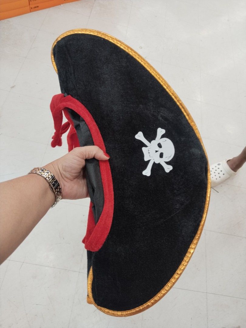Black and Red Pirate Hat with Skull and Crossbones (Category: Caps & Hats) located in Manila. Submitted by zdmal (Listing ID 1469651940, Image 1). Description: - Color: Black with red trim and gold ribbon edge - Design: Classic white skull and crossbones graphic - Material: Soft and comfortable fabric - Perfect for: Halloween costumes and pirate-themed parties - Availability: 2 pieces in stock.