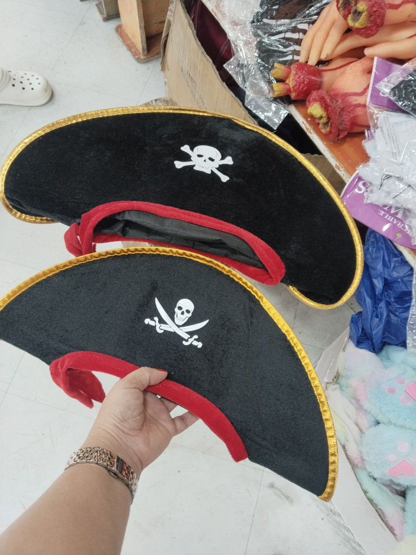 Black and Red Pirate Hat with Skull and Crossbones (Category: Caps & Hats) located in Manila. Submitted by zdmal (Listing ID 1469651940, Image 2). Description: - Color: Black with red trim and gold ribbon edge - Design: Classic white skull and crossbones graphic - Material: Soft and comfortable fabric - Perfect for: Halloween costumes and pirate-themed parties - Availability: 2 pieces in stock.