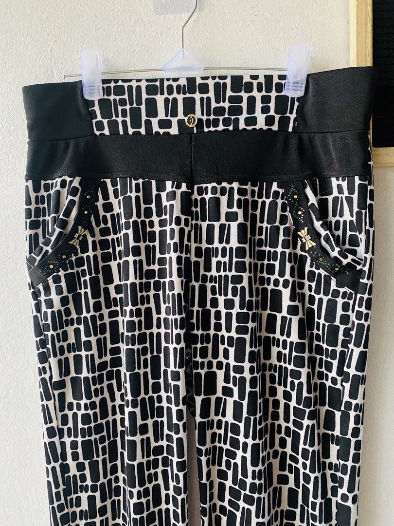 Black and White Geometric Print Pants (Category: Jeans) located in Caloocan City. Submitted by lovemyclothes21 (Listing ID 1469611535, Image 2). Description: - Bold black and white geometric all-over pattern - Comfortable wide elastic waistband with chic black side panels - Two functional front pockets accented with elegant gold hardware and studs - Trendy cuffed ankles at the bottom - Stretchy, high-quality material for a flexible fit - Size: Fi