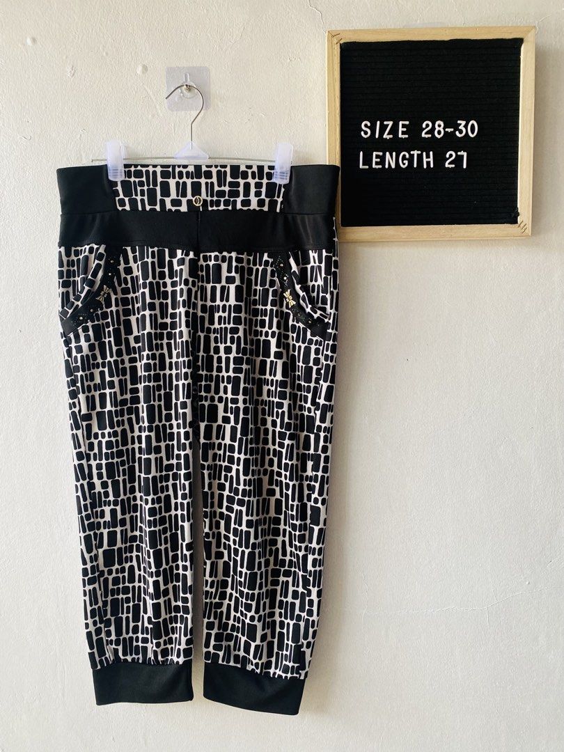 Black and White Geometric Print Pants (Category: Jeans) located in Caloocan City. Submitted by lovemyclothes21 (Listing ID 1469611535, Image 1). Description: - Bold black and white geometric all-over pattern - Comfortable wide elastic waistband with chic black side panels - Two functional front pockets accented with elegant gold hardware and studs - Trendy cuffed ankles at the bottom - Stretchy, high-quality material for a flexible fit - Size: Fi