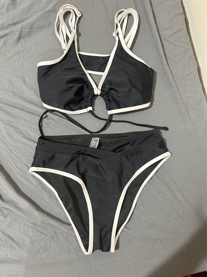 Black and White Two-Piece Bikini Set (Category: Bikinis & Swimsuits) located in Taytay. Submitted by declutter_random (Listing ID 1469598236, Image 1). Description: - used only once - Classic black color with stylish white trim - Flattering high-waisted bottoms - Chic front cutout detail with gathered fabric - Adjustable straps for a customized fit.
