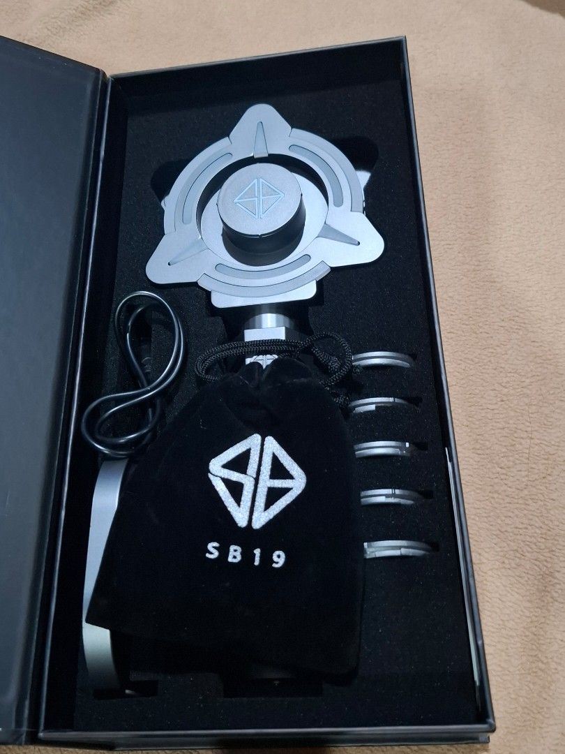 Black Box with Silver Foil Design (Category: Accessory Holder, Box & Organizers) located in Agdangan. Submitted by snowsmum (Listing ID 1469680726, Image 2). Description: FOR SALE: Brand New SB19 ELESBI Lightstick Version 4 (Dusk) Selling a 100% brand new, authentic, and unused official SB19 ELESBI V4 (Dusk) lightstick. Complete with its original packaging and all inbox inclusions. Product Specifications & Features • Color: Dusk • Design: Windmil