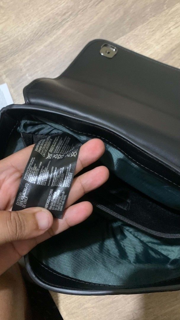Black Crossbody Bag with Geometric Pattern (Category: Sling Bags) located in Manila. Submitted by prime.dlor (Listing ID 1469742952, Image 3). Description: - Authentic Black Lacoste crossbody bag with original tags still attached - Chic geometric stamped pattern all over the durable PVC body - Secure metal clasp closure on the front flap - Adjustable shoulder strap for a customized, comfortable fit - Clean green fabric lining inside - Convenient 