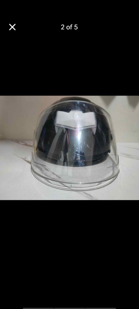 Black e-bike helmet with 2 visors (Category: Bicycles) located in Manila. Submitted by billythekid05 (Listing ID 1469721433, Image 2). Description: - Style: Black half-face motorcycle helmet - Visor: Attached clear visor with no major scratches - Closure: Adjustable chin strap with quick-release red buckle - Interior: Comfortable black padding with a red mesh insert - Condition: Clean outer shell, ready for daily rides.