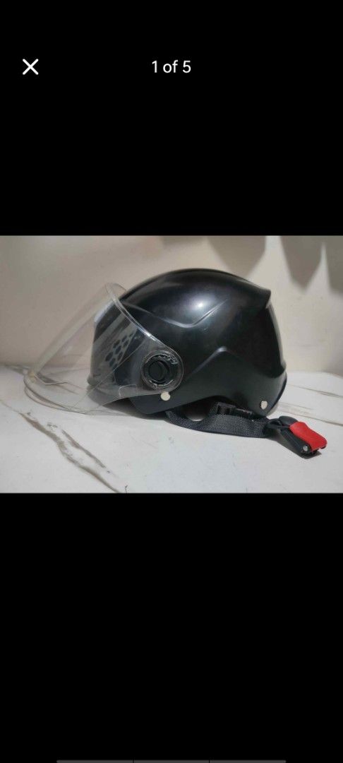 Black e-bike helmet with 2 visors (Category: Bicycles) located in Manila. Submitted by billythekid05 (Listing ID 1469721433, Image 1). Description: - Style: Black half-face motorcycle helmet - Visor: Attached clear visor with no major scratches - Closure: Adjustable chin strap with quick-release red buckle - Interior: Comfortable black padding with a red mesh insert - Condition: Clean outer shell, ready for daily rides.