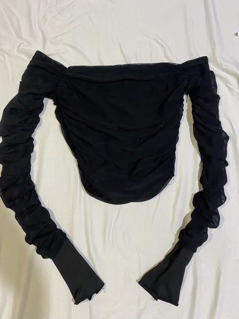Black mesh off-shoulder long sleeve ruched top (Category: Longsleeves) located in Bulacan. Submitted by nonu_sells (Listing ID 1469673142, Image 1). Description: - Color: Black - Style: Off-shoulder mesh top with fitted silhouette - Sleeves: Long sleeves with heavy ruching and solid wrist cuffs - Material: Stretchy, sheer fabric - Versatility: Great basic piece for layering or going out - Condition: Brand new / Excellent.