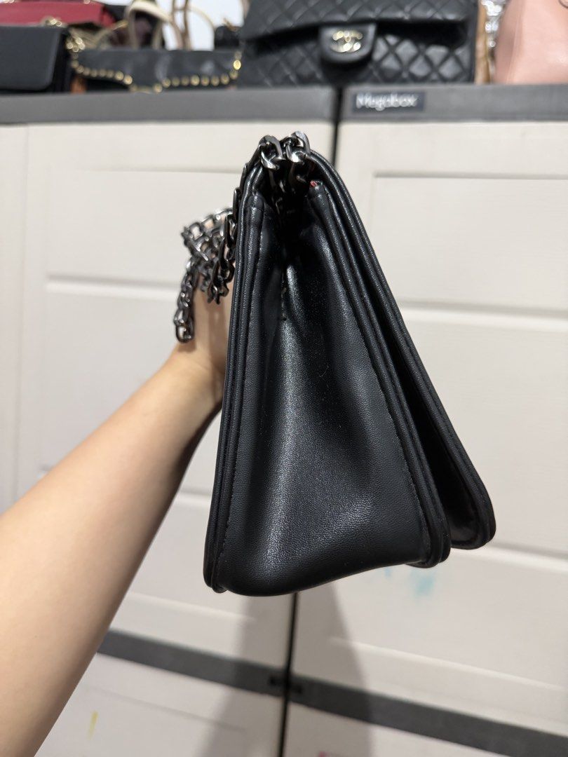 Black Quilted Crossbody Bag with Chain Strap (Category: Cross-body Bags) located in Quezon City. Submitted by skyleeeee (Listing ID 1469583686, Image 3). Description: - Color & Material: Classic black soft faux leather - Hardware & Closure: Gunmetal hardware with a secure turn-lock flap closure - Strap: Sturdy, adjustable dark chain shoulder strap - Interior: Clean lining complete with a handy slip compartment - Condition: Minimal wear on corners