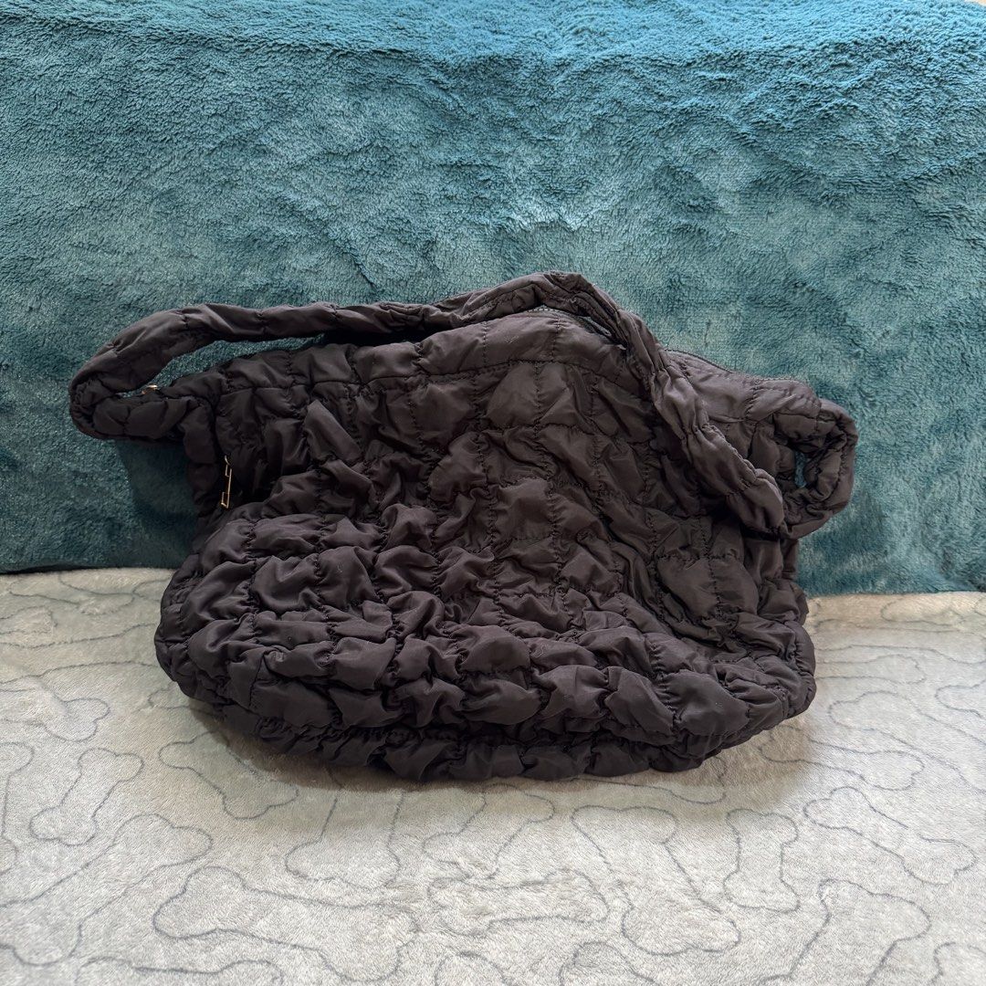 Black Quilted Oversized Shoulder Bag – COS-Inspired (Category: Cross-body Bags) located in Baguio. Submitted by mrnhjl (Listing ID 1469609382, Image 2). Description: Black oversized quilted shoulder bag with a soft, puffy texture and a relaxed, slouchy shape. COS-inspired design, bought in Korea. - Synthetic fabric - Oversized quilted design - Padded shoulder strap - Top zipper closure - Gold-tone zipper pulls Well-used. The bag has visible creas