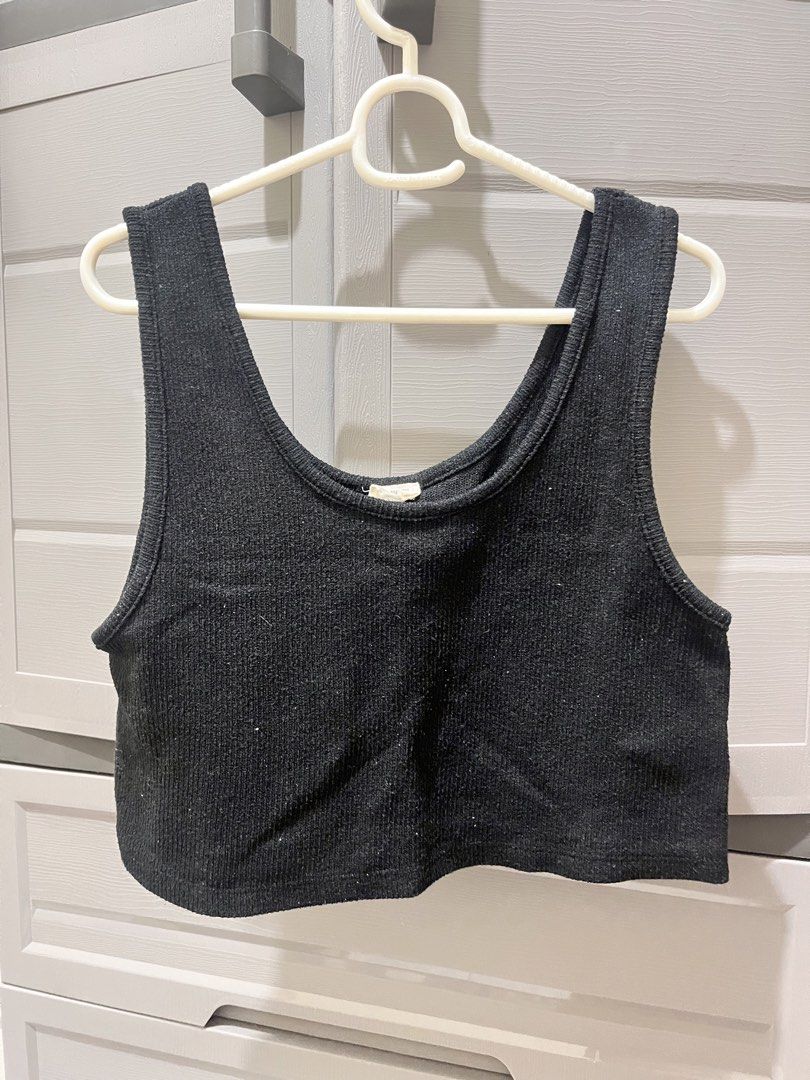 Black Ribbed Crop Tank Top (Category: Sleeveless) located in Taguig. Submitted by notyoursam (Listing ID 1469690565, Image 1). Description: - Color: Black - Style: Ribbed crop top with scoop neckline and wide straps - Material: Stretchy knit texture - Fit: Cropped length that sits at the waist - Condition: Clean, excellent pre-loved condition - Versatility: Perfect casual basic, easy to match with high-waisted denim or skirts.