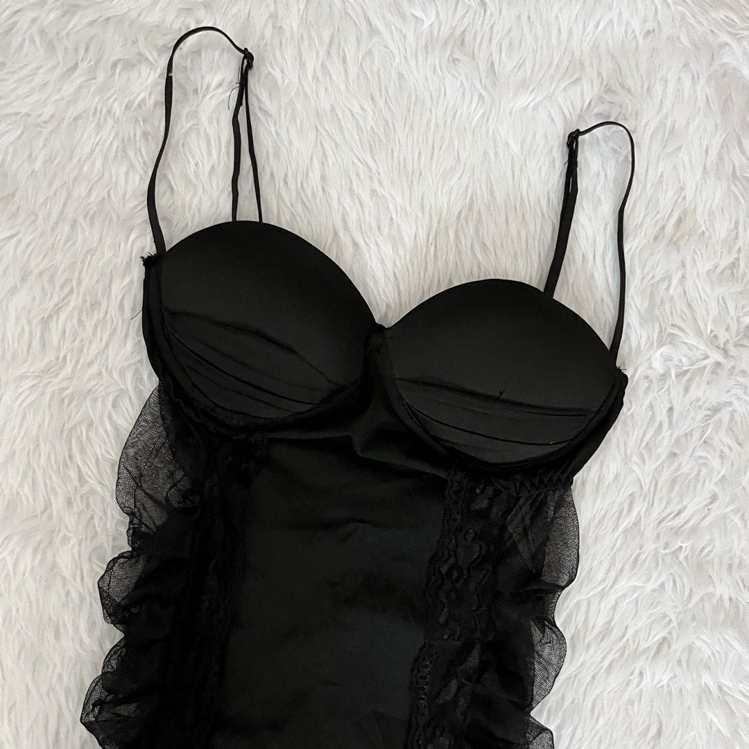 Black Ruffled Mini Dress with Underwire Cups (Category: Dresses) located in Maasin. Submitted by taraa18 (Listing ID 1469584405, Image 2). Description: - Brand: Never worn - Style: Flirty, fitted mini dress in black - Cups: Underwire with padded cups for support - Design: Smooth satin front panels with sheer ruffled mesh sides and delicate lace trim - Back: Fully gathered with layered mesh ruching - Straps: Adjustable spaghetti straps.