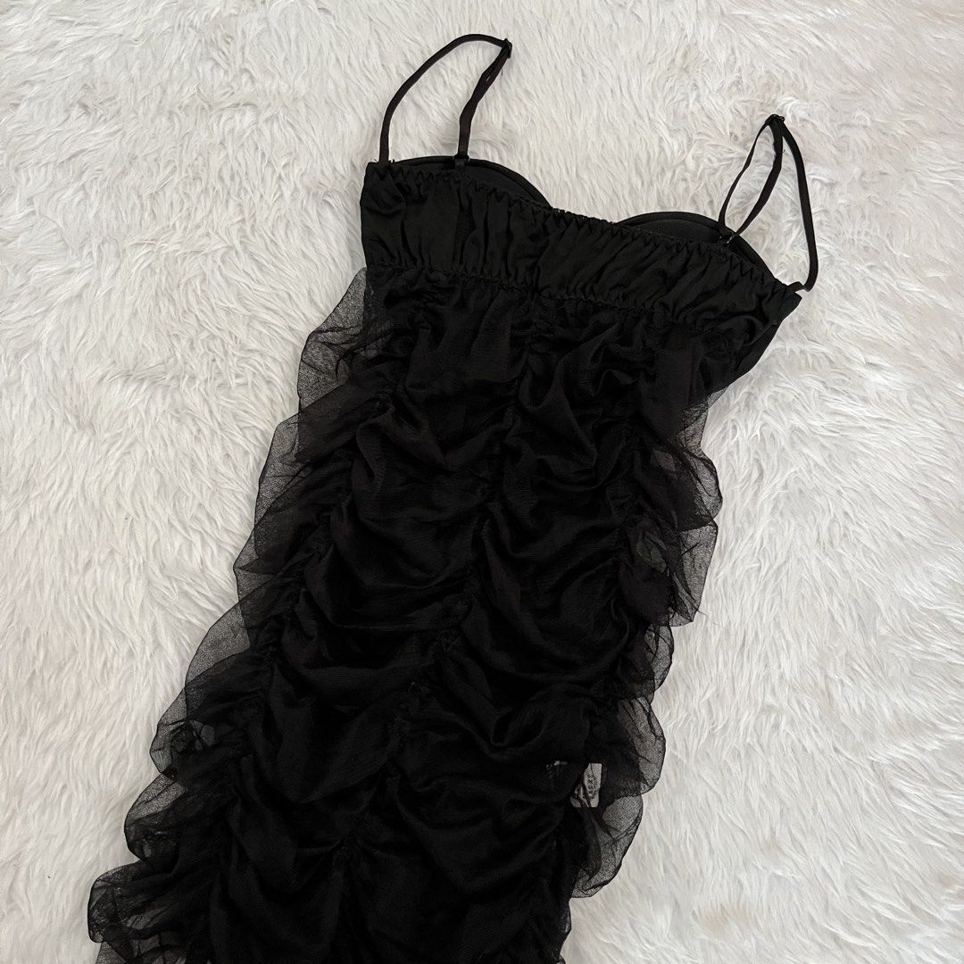Black Ruffled Mini Dress with Underwire Cups (Category: Dresses) located in Maasin. Submitted by taraa18 (Listing ID 1469584405, Image 3). Description: - Brand: Never worn - Style: Flirty, fitted mini dress in black - Cups: Underwire with padded cups for support - Design: Smooth satin front panels with sheer ruffled mesh sides and delicate lace trim - Back: Fully gathered with layered mesh ruching - Straps: Adjustable spaghetti straps.