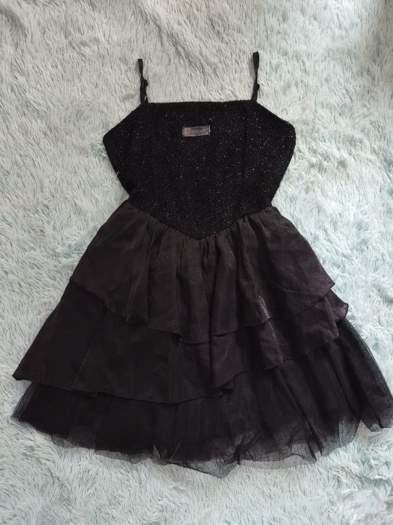 Black sparkly layered spaghetti strap mini dress (Category: Dresses) located in Quezon City. Submitted by alluring.avenue (Listing ID 1469599807, Image 1). Description: - Color: Black - Style: Dark alternative / Party dress - Bodice: Sparkly textured with a small metal brand plaque at the center - Straps: Adjustable thin spaghetti straps - Skirt: Multi-layered tiered skirt with sheer dark fabric and tulle underneath - Condition: Excellent - Perfe