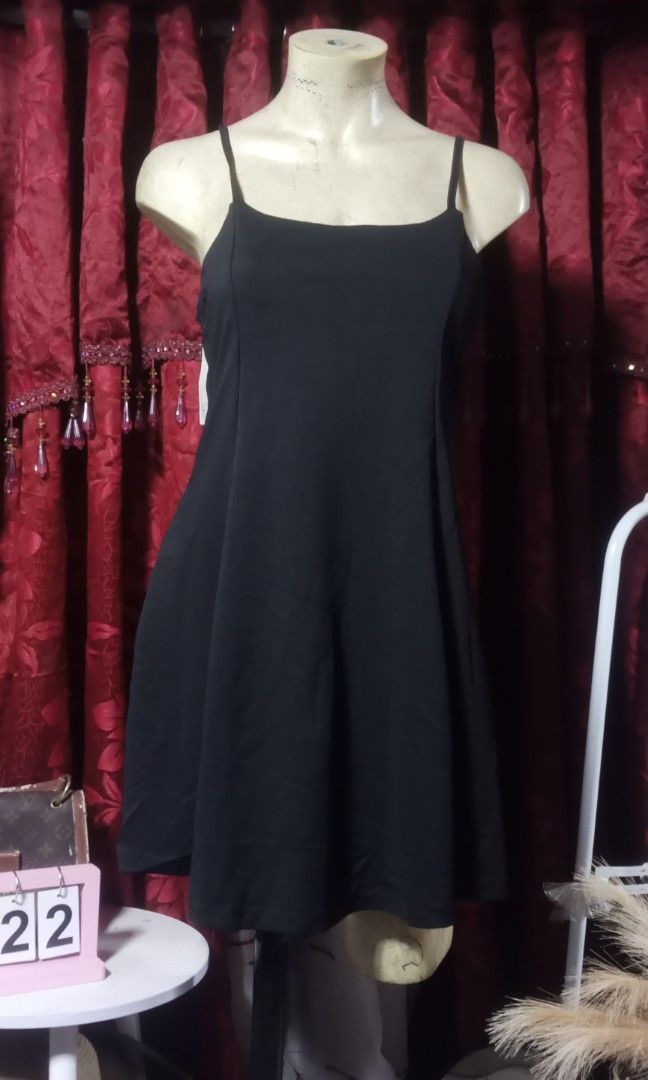 Black string mini dress (Category: Dresses) located in Manila. Submitted by wheneity67thifted (Listing ID 1469617087, Image 2). Description: The image shows a classic black spaghetti-strap skater or A-line mini dress with a square neckline.
