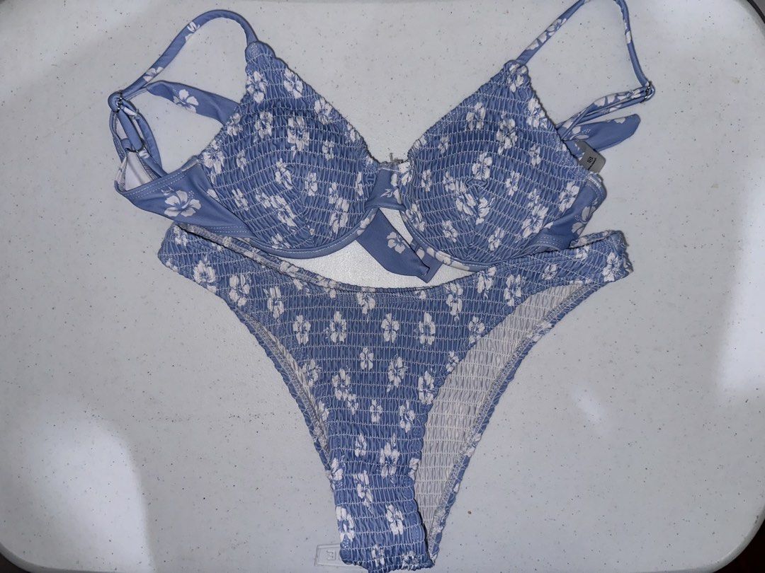 Blue and white floral bikini set (Category: Bikinis & Swimsuits) located in Pasig City. Submitted by prelovedbysco (Listing ID 1469590783, Image 3). Description: - Blue and white floral print bikini set - All-over smocked texture on top and bottom - Underwire top with adjustable straps and cute front tie accent - High-cut bottoms with stretchy ruched fabric - Material: Polyester and elastane - Care: Wash dark colors separately - RFS: decluttering