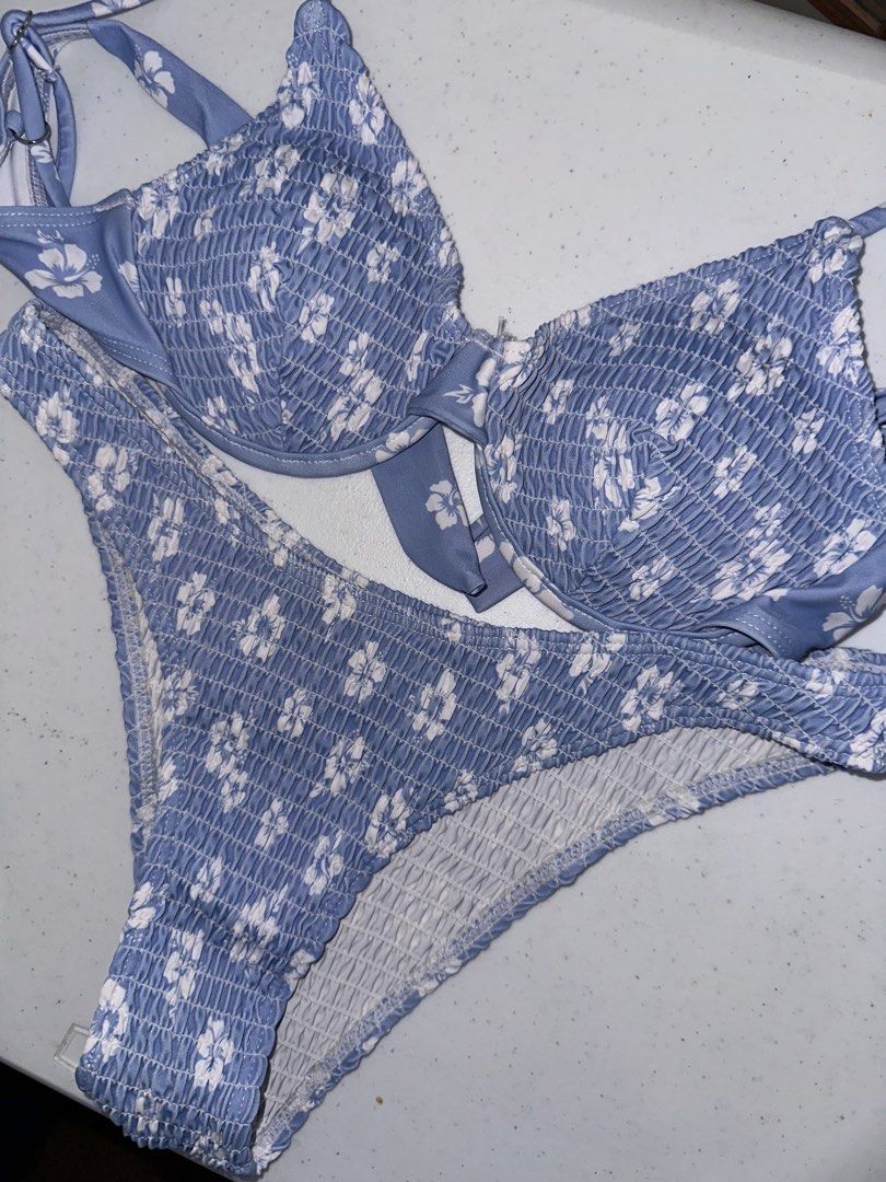 Blue and white floral bikini set (Category: Bikinis & Swimsuits) located in Pasig City. Submitted by prelovedbysco (Listing ID 1469590783, Image 2). Description: - Blue and white floral print bikini set - All-over smocked texture on top and bottom - Underwire top with adjustable straps and cute front tie accent - High-cut bottoms with stretchy ruched fabric - Material: Polyester and elastane - Care: Wash dark colors separately - RFS: decluttering