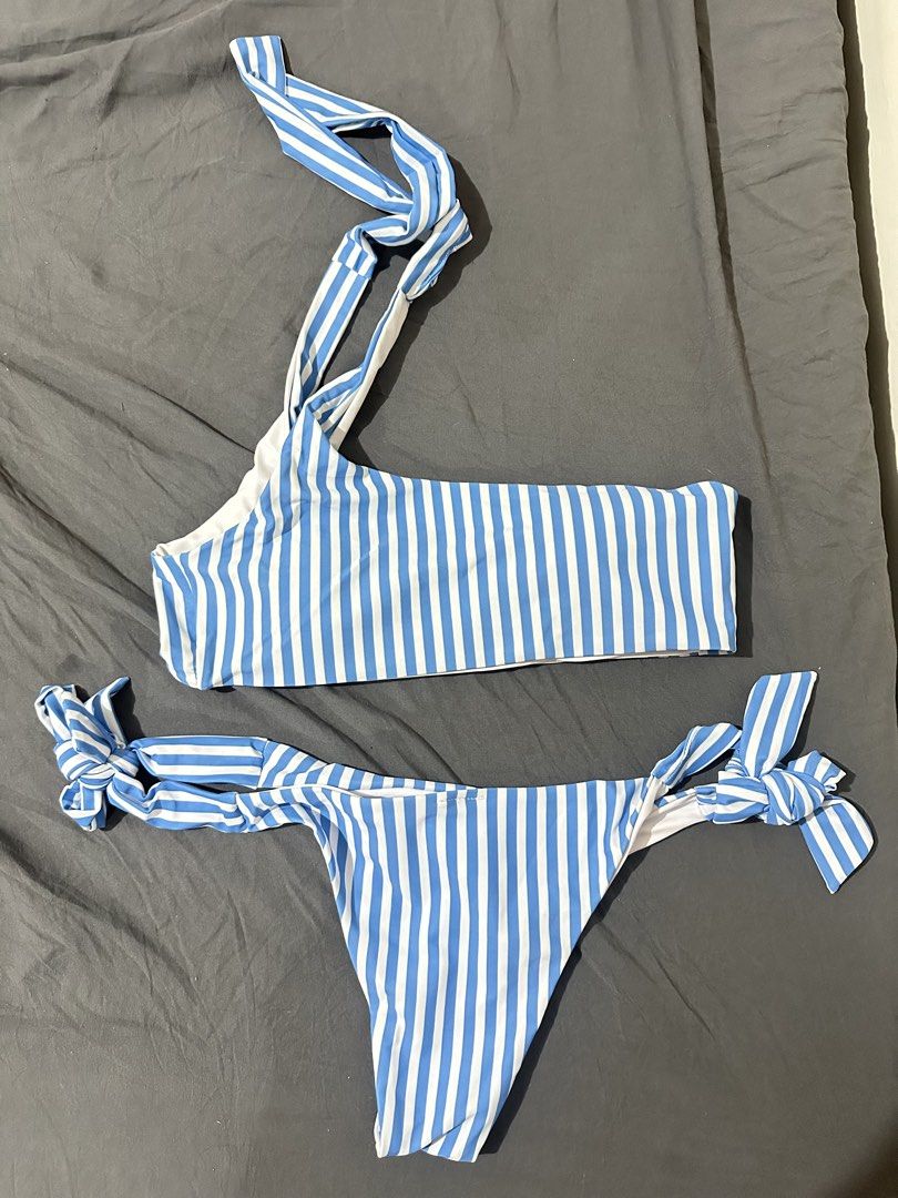Blue and White Striped One-Shoulder Bikini Set (Category: Bikinis & Swimsuits) located in Taytay. Submitted by declutter_random (Listing ID 1469600038, Image 1). Description: - Style: Blue and white vertical striped bikini - Top: One-shoulder design with multi-strap detail - Bottoms: Adjustable side ties at both hips - Condition: used only once - Fabric: Soft material with comfortable white lining inside - Ideal for: Beach wear, pool parties, and