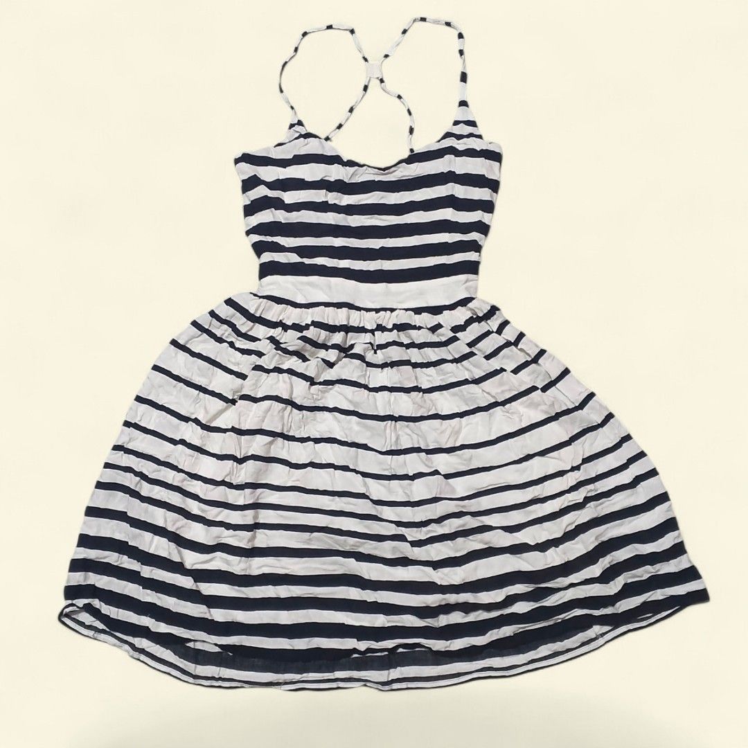 Blue and White Striped Spaghetti Strap Dress (Category: Dresses) located in Indang. Submitted by shanlennon09 (Listing ID 1469622652, Image 1). Description: - Navy blue and white horizontal stripe design - Fitted bodice with a flattering flared, gathered skirt - Trendy thin criss-cross straps at the back - Perfect casual piece for warm weather and sunny days - Versatile style: looks great with sandals or sneakers - Condition: Brand new / Excellen