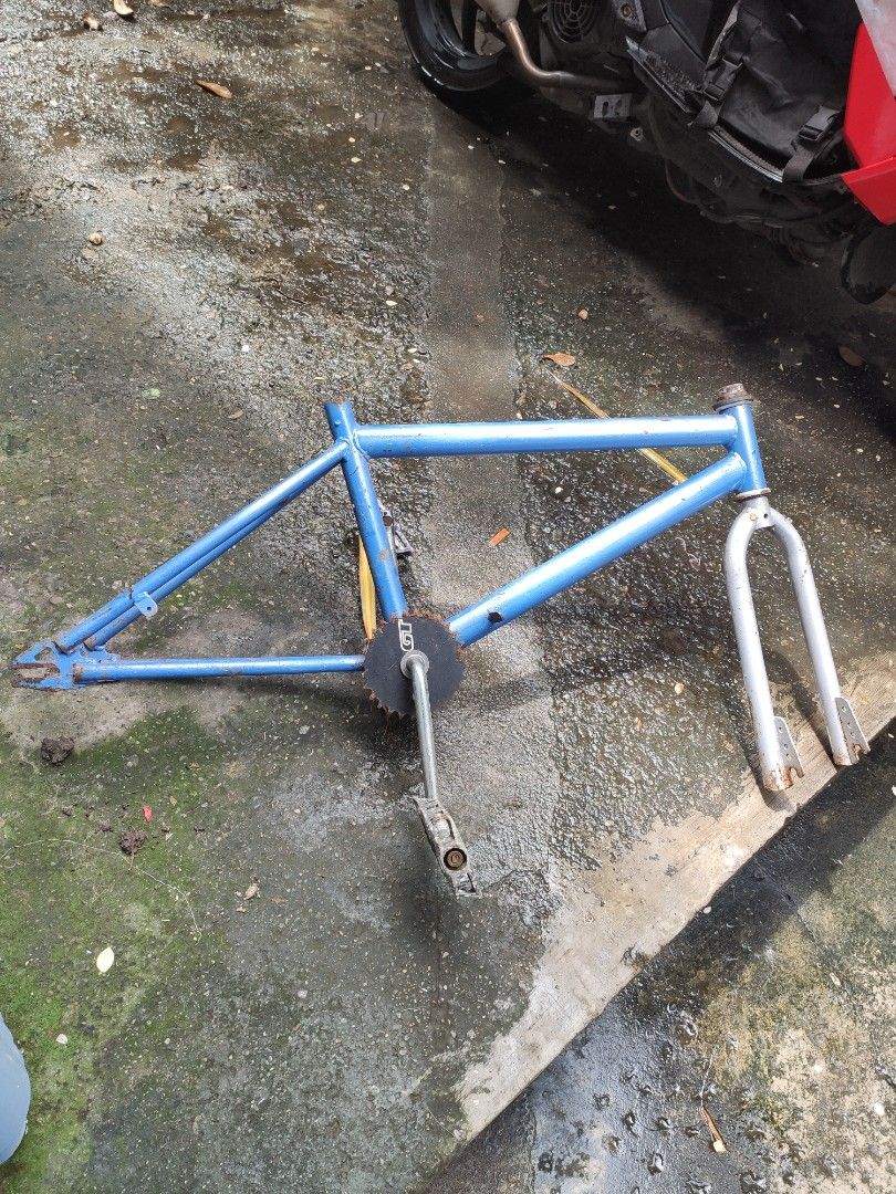 Blue BMX Bicycle Frame with Fork and Crankset (Category: Bicycles) located in Valenzuela. Submitted by dendi.ph (Listing ID 1469577447, Image 2). Description: - Blue BMX bicycle frame bundle - Includes silver front fork, chainring with GT branding, cranks, and pedals - Shows visible rust on components and paint wear throughout - Solid and sturdy base - Perfect for custom bike restoration or vintage builds.