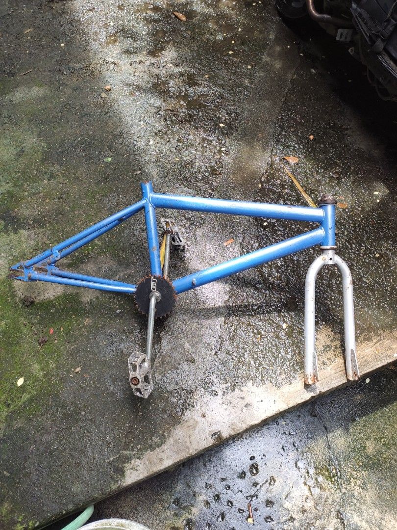 Blue BMX Bicycle Frame with Fork and Crankset (Category: Bicycles) located in Valenzuela. Submitted by dendi.ph (Listing ID 1469577447, Image 3). Description: - Blue BMX bicycle frame bundle - Includes silver front fork, chainring with GT branding, cranks, and pedals - Shows visible rust on components and paint wear throughout - Solid and sturdy base - Perfect for custom bike restoration or vintage builds.