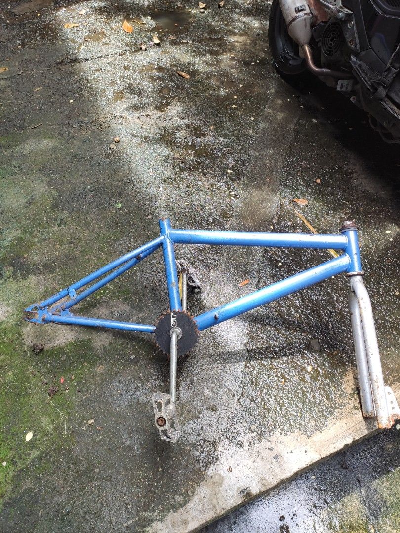 Blue BMX Bicycle Frame with Fork and Crankset (Category: Bicycles) located in Valenzuela. Submitted by dendi.ph (Listing ID 1469577447, Image 1). Description: - Blue BMX bicycle frame bundle - Includes silver front fork, chainring with GT branding, cranks, and pedals - Shows visible rust on components and paint wear throughout - Solid and sturdy base - Perfect for custom bike restoration or vintage builds.