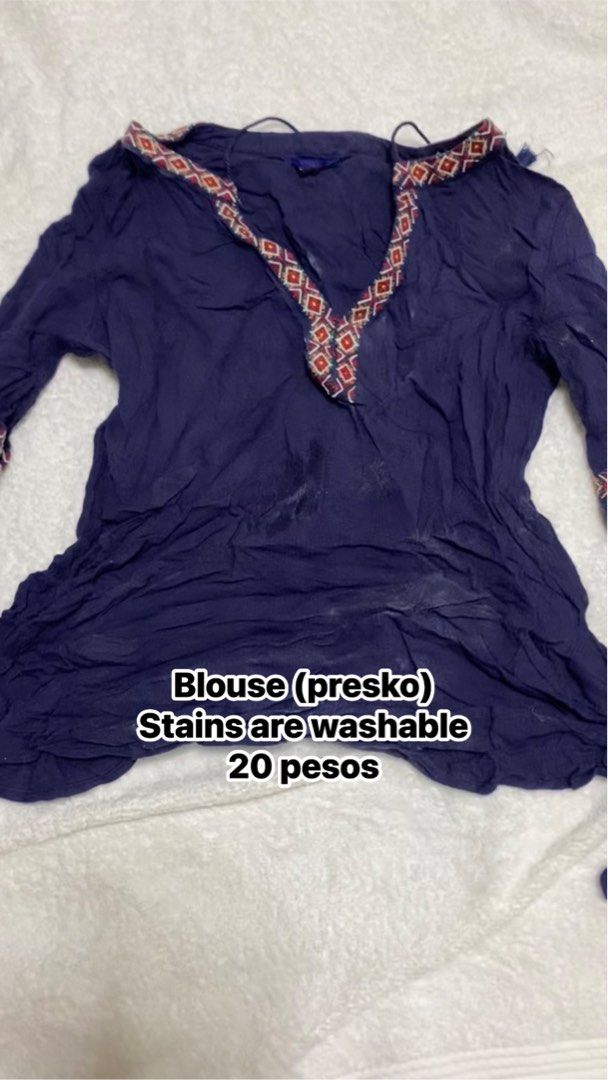 Blue Boho Blouse with Patterned Collar (Category: Blouses) located in Manila. Submitted by remotorose29730 (Listing ID 1469643433, Image 1). Description: - Price: ₱20 only (Super cheap find!) - Color & Material: Dark blue, lightweight, and very breathable fabric - Design: Colorful geometric pattern along the V-neckline and sleeve cuffs - Features: Long sleeves included - Condition: Has minor white stains on the front and lower body (easy to wash 