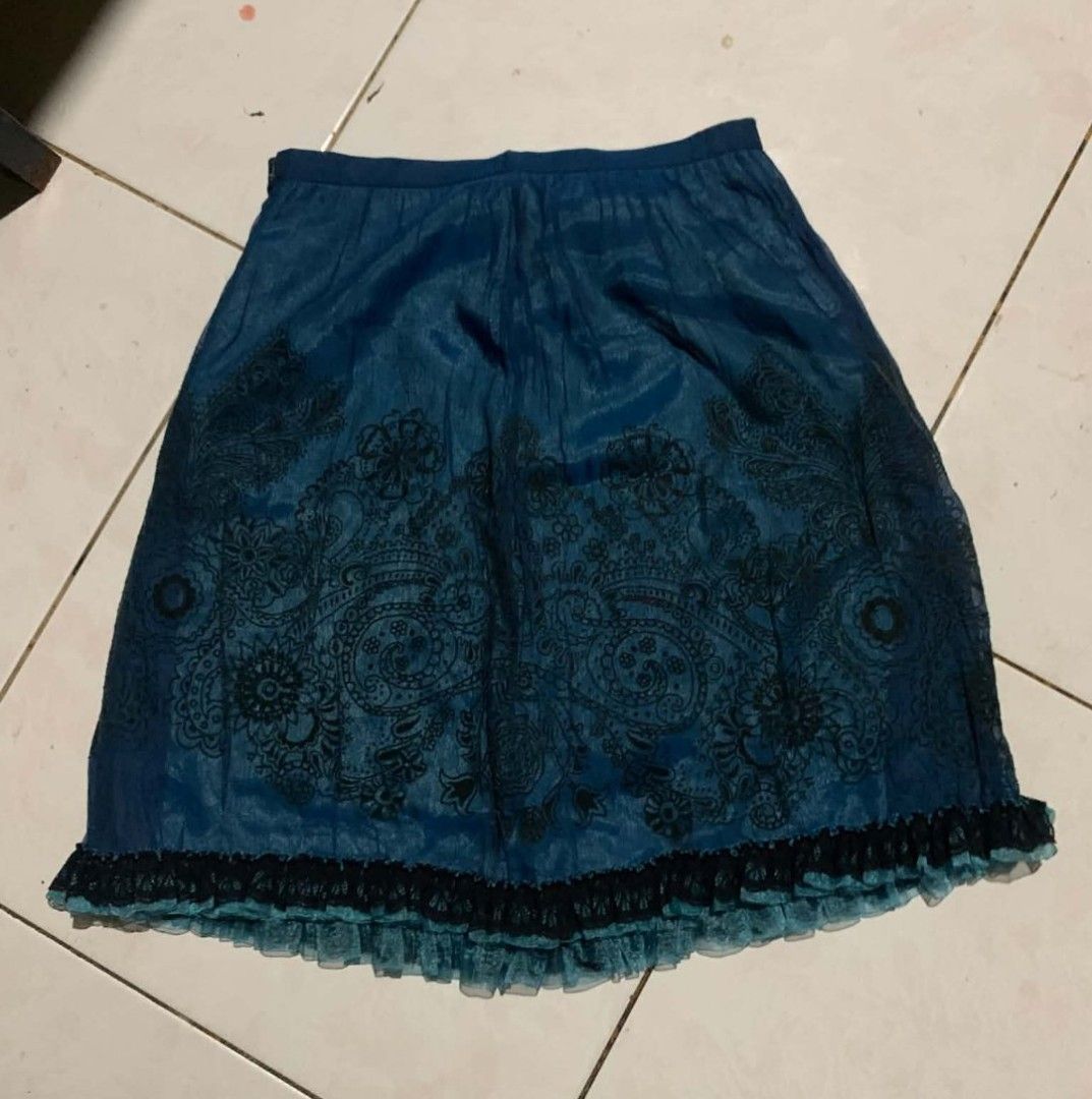 Blue Boho Floral Print Ruffle Hem Skirt (Category: Skirts) located in Manila. Submitted by atashaaaaa (Listing ID 1469693101, Image 1). Description: - Deep blue skirt with intricate dark floral and paisley patterns - Layered black and teal mesh ruffle trim along the bottom hem - Comfortable elastic waistband for an easy pull-on fit - Lightweight material with a slight sheen - EUC, stylish, and easy to match!.