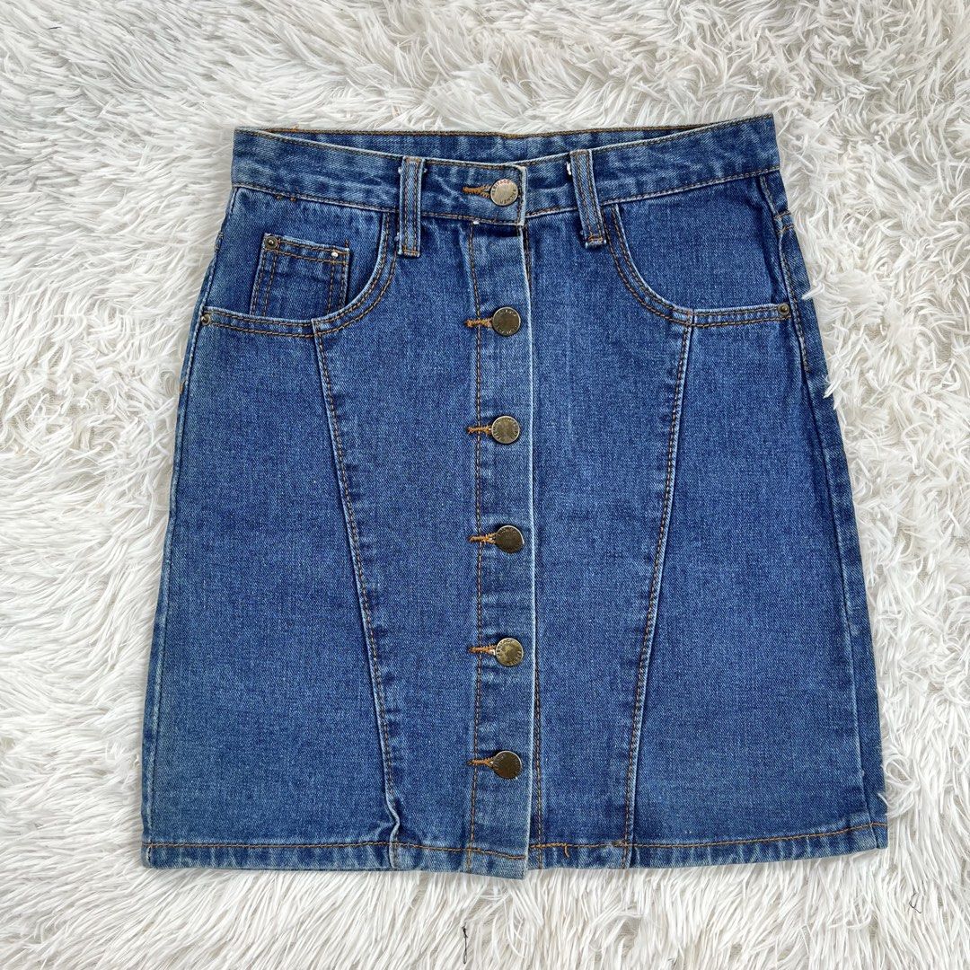 Blue Denim Button Front Mini Skirt Size 25 (Category: Skirts) located in Cuyapo. Submitted by Ashtyn.Pre.Loved (Listing ID 1469606608, Image 1). Description: - Style: Classic high-waisted blue denim mini skirt - Details: Full button-up front with contrast topstitching and functional front pockets - Size: Tagged size 25 - Length: 16 inches - Condition/Vibe: Great versatile piece, easy to style with tees, tanks, or sweaters for casual outfits.