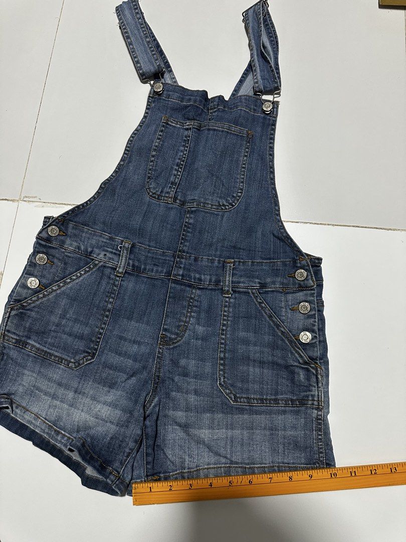 Blue Denim Short Overalls Romper (Category: Rompers) located in Quezon City. Submitted by breakstuf50 (Listing ID 1469737454, Image 1). Description: - Style: Medium wash denim short overalls - Features: Adjustable shoulder straps, front zipper closure, chest pocket, and side patch pockets - Details: Side buttons at the waist - Measurements: Roughly 13" across the waist and 31" in total length - Condition/Vibe: Classic casual piece, easy to throw 