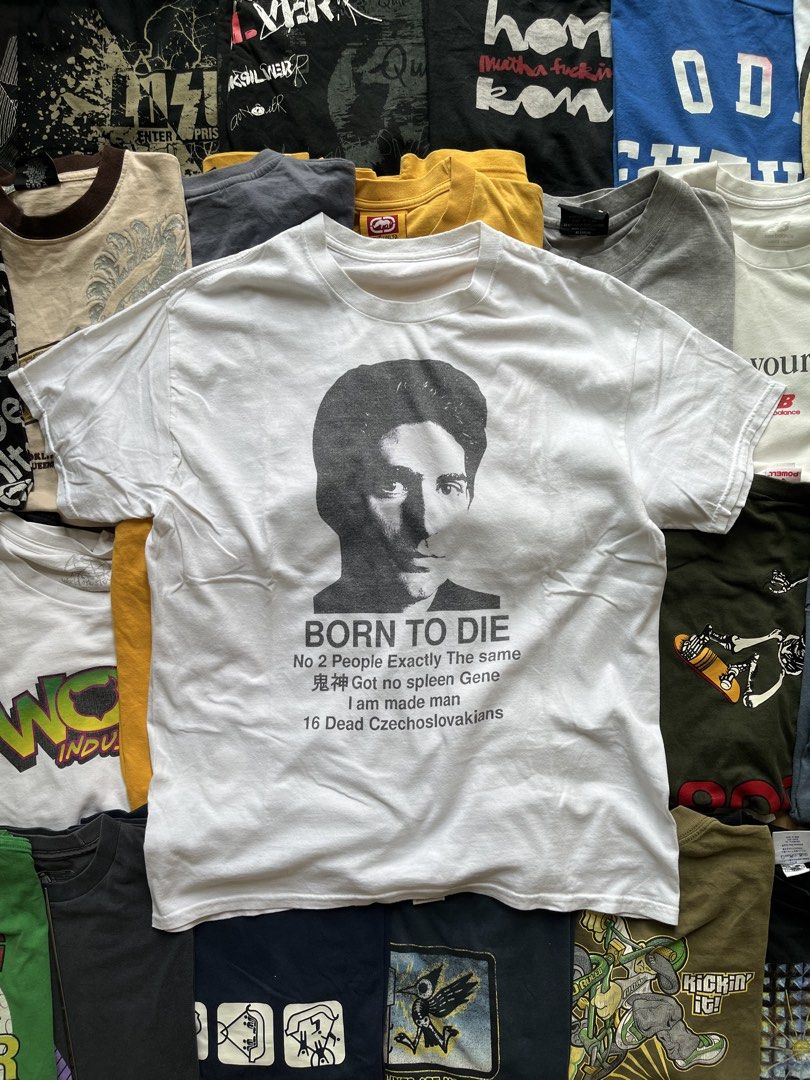 Born To Die Graphic T-Shirt White (Category: Tshirts & Polo Shirts ) located in Baao. Submitted by plainclothesdept (Listing ID 1469709727, Image 1). Description: y2k born to die width - 21 in. length - 28 in. no flaws - Color: White - Design: Face print with eclectic text (Born To Die, 16 Dead Czechoslovakians, Japanese characters) - Material: 100% Cotton - Fit: Short sleeves, crew neck - Style: Casual everyday tee with a unique, edgy vibe - Con