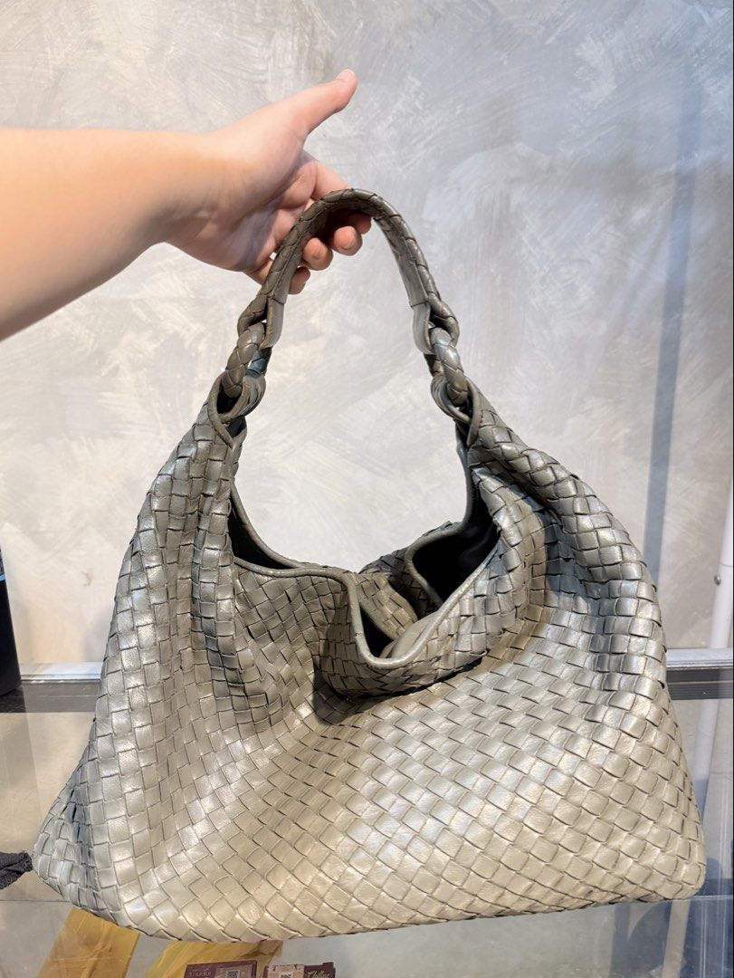 Authentic Bottega Veneta Sloane Hobo Bag (Category: Luxury Bags & Wallets) located in Santiago. Submitted by dobongsoon (Listing ID 1469731178, Image 2). Description: - Brand: Bottega Veneta - Material: Premium grey etoupe color with signature intrecciato woven design - Style: Hobo bag with soft structure and braided handle detail - Interior: Fabric-lined with brand label and authenticity code tag - Origin: Made in Italy craftsmanship - Condition