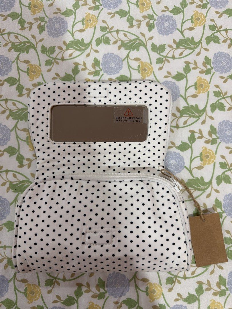 brandy melville polka dot makeup pouch (Category: Purses & Pouches) located in Manila. Submitted by jenfer80 (Listing ID 1469669287, Image 2). Description: - Design: Classic black and white polka dot pattern - Style: Foldable with a secure flap closure and neat piping trim - Material: Soft fabric body with a flexible structure - Details: Includes a cute blank brown tag attached by twine - Condition: Brand new and ready to ship.