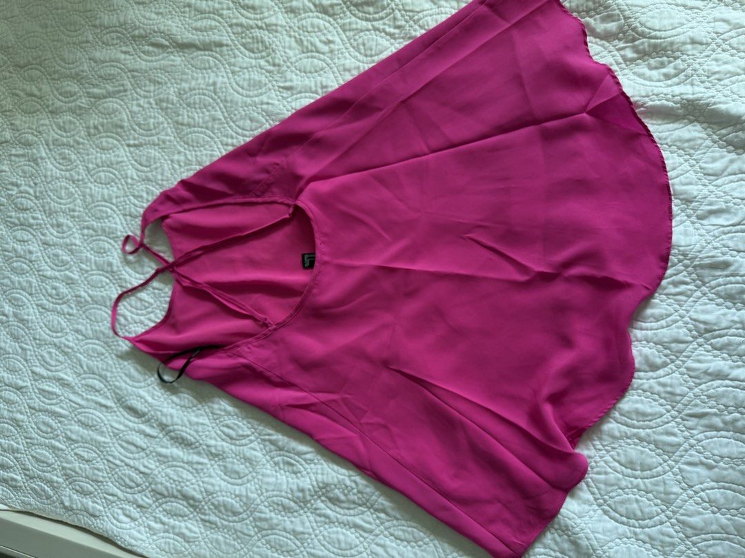Bright Pink Layered Cami Tank Top Spaghetti Straps (Category: Sleeveless) located in Taguig. Submitted by almamercedes (Listing ID 1469594813, Image 2). Description: - Color: Vibrant hot pink - Design: Scoop neckline, thin spaghetti straps, open back with stylish strap details - Hem: Flowy, layered ruffled hem - Material: Lightweight, sheer chiffon-like fabric - Styling: Ideal summer top to match with denim jeans or shorts - Condition: Excellent,