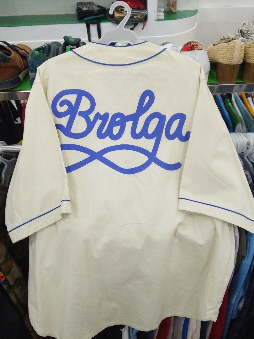Brolga H&M Cream Blue Baseball Jersey (Category: Activewear) located in Manila. Submitted by afreemf (Listing ID 1469644145, Image 2). Description: - Color: Cream with blue trim and matching buttons - Design: Brolga chest graphic and large blue 'Brolga' script lettering across the back - Fit: Relaxed short-sleeve fit - Style: Ideal for casual everyday streetwear looks - Condition: Brand new/Excellent.